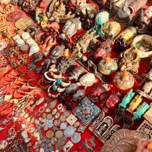 A vibrant display of vintage and handmade items at a bustling market stall.
